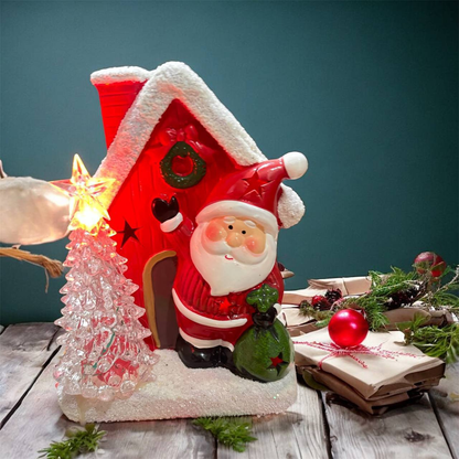 Casita decorativa de Papá Noel con árbol y muñeco de nieve.13.0 NAVIDAD